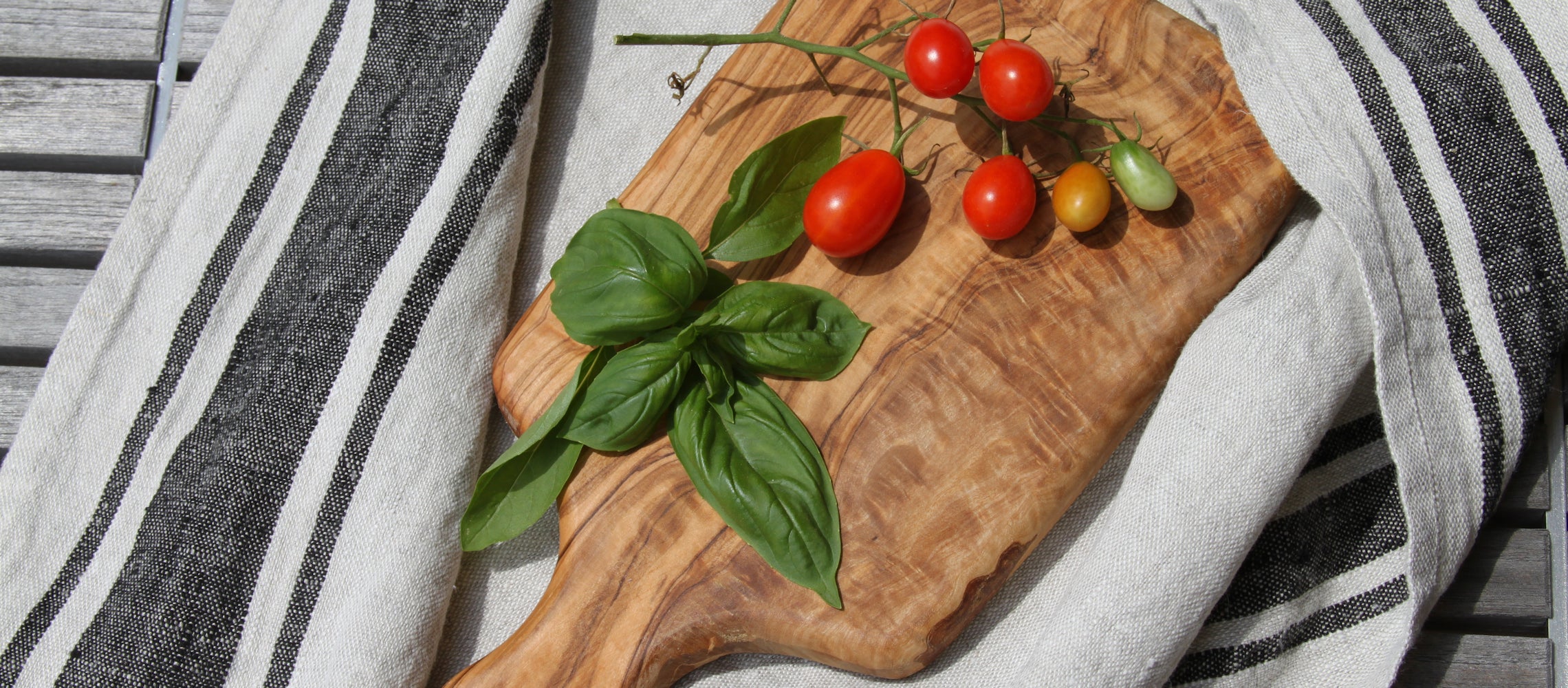 Linen kitchen towels with fresh basil and tomatoes